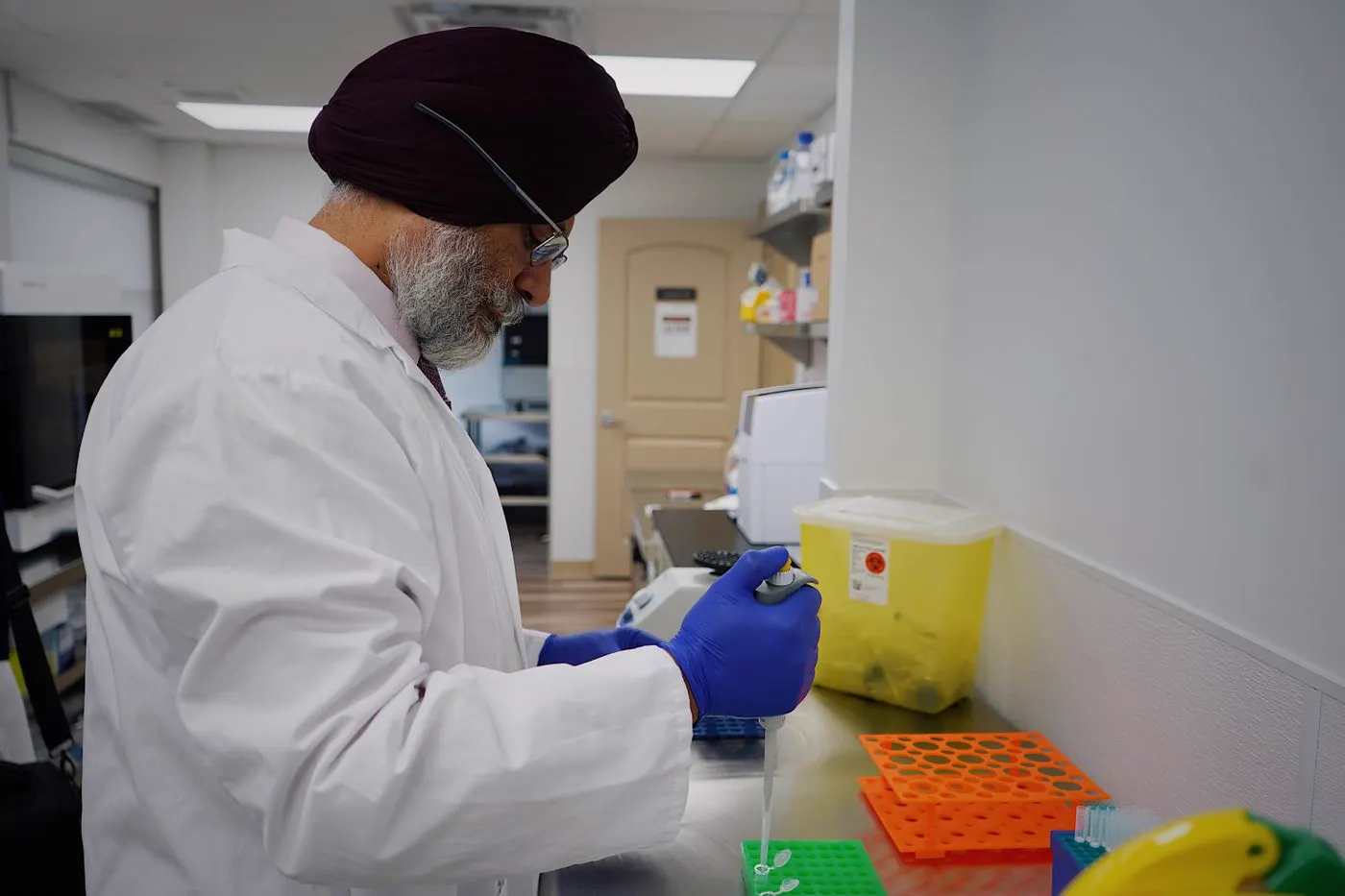 Laboratory technician in gloves handling samples
